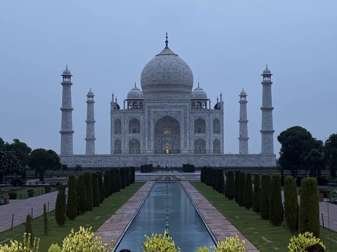 The Taj Mahal at sunrise reflected in the long pool, Agra, India